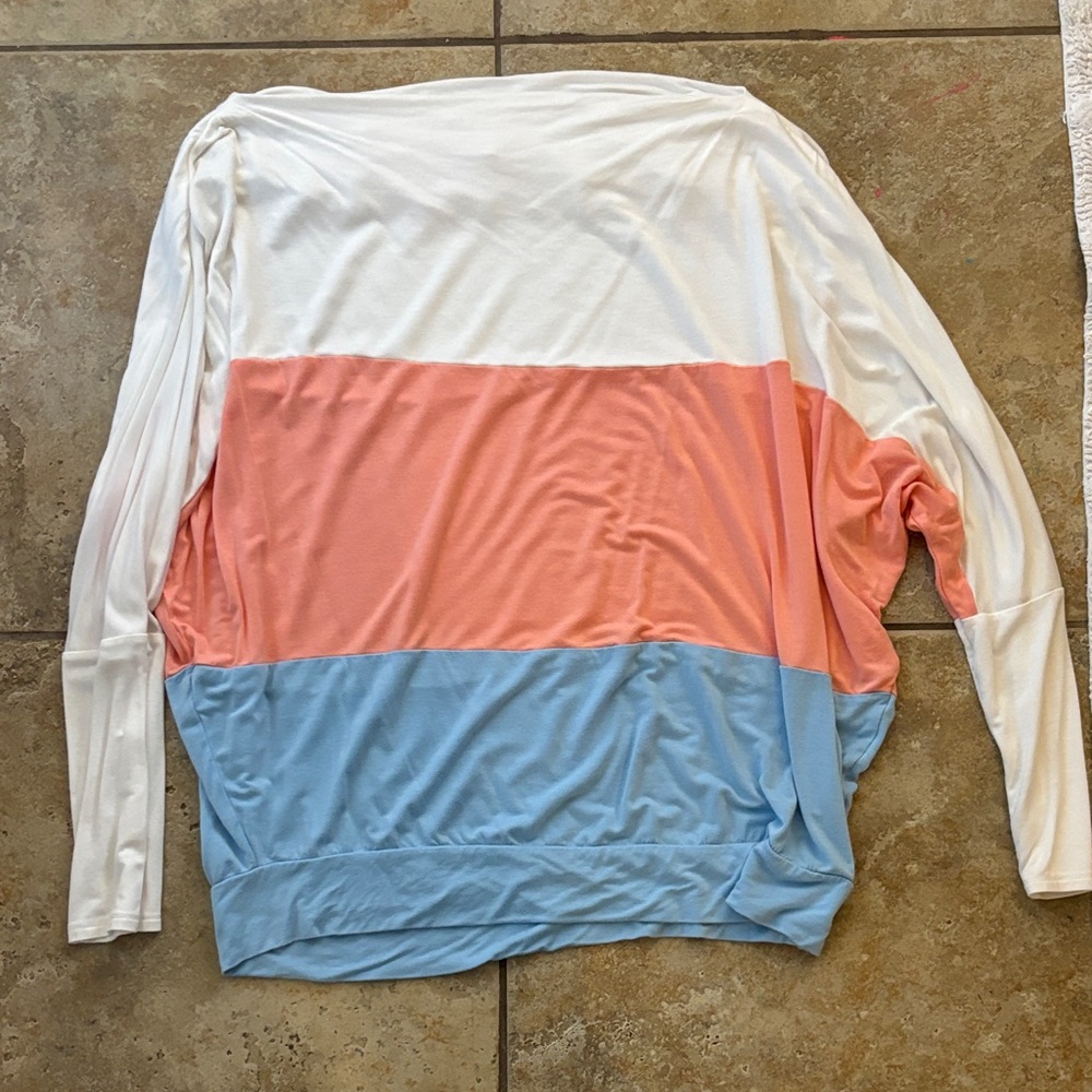 Slouchy, off the shoulder pink, white, and blue long sleeve shirt.